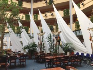 a restaurant with tables and chairs and white tents at Beachhouse Tossens in Tossens