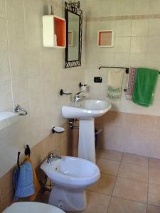 a bathroom with a white sink and a toilet at B&B La Tasgia in Aggius