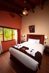 Cama o camas de una habitación en Hotel Mabey Urubamba