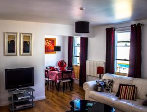 a living room with a couch and a table at Tower View Apartment in Cushendall