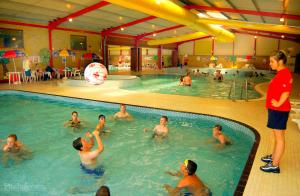 a group of people in a swimming pool at The Beach Huts - Camber Sands in Camber