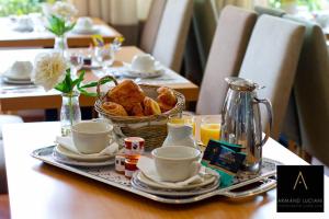 a table with a tray of food and a basket of bread at Hotel Santa Maria in Saint-Florent