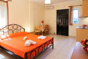 a bedroom with a bed with towels on it at Studios Niki B in Lefkada Town