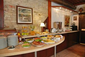 a buffet with a lot of food on a counter at City Gate in Vilnius