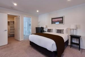 a bedroom with a large bed and a bathroom at Esperance Landing in Dover