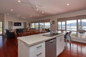 a kitchen and living room with a table and chairs at Esperance Landing in Dover