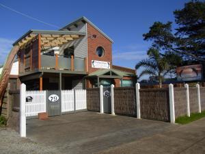 a house with a white fence in front of it at Black Dolphin Waterfront Apartment in San Remo