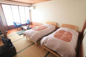 Postel nebo postele na pokoji v ubytování Hotel New Ohruri