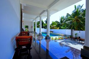 a view of the pool from the porch of a house at Lavenro Hotel & Resort in Deniyaya