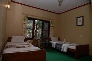 Postel nebo postele na pokoji v ubytování Nepali Cottage Guest House