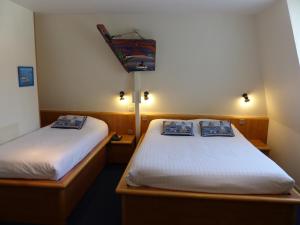 Postel nebo postele na pokoji v ubytování Hotel Le Marin