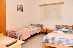 a room with three beds and a desk with a computer at Villa Valenta-Klis near Split, heated pool & view in Klis +38 photos