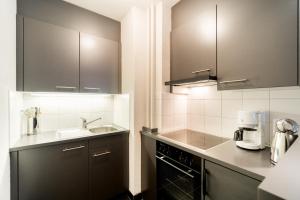 Kuchyň nebo kuchyňský kout v ubytování Appartements Hofquartier