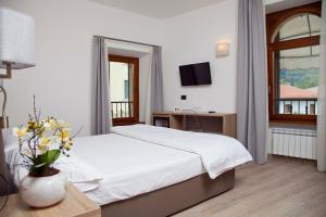 Posteľ alebo postele v izbe v ubytovaní Albergo Grobberio