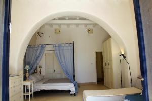 a bedroom with two beds and an archway at Alicudi Giardino dei Carrubi- al gradino 365 in Alicudi