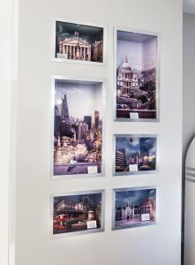 a group of pictures on a white wall at Point A Hotel London Shoreditch in London