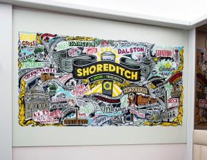 a door with a collage of stickers on it at Point A Hotel London Shoreditch in London