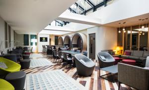 a restaurant with tables and chairs in a room at Point A Hotel London Shoreditch in London +32 photos