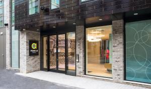 a store front with glass doors on a building at Point A Hotel London Shoreditch in London