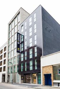 a large building with a sign in front of it at Point A Hotel London Shoreditch in London
