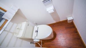 a bathroom with a white toilet in a room at Forest West Nishi in Nakijin +19 photos