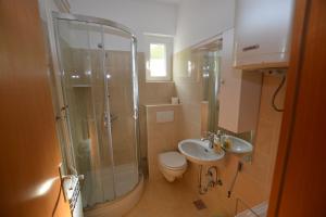 a bathroom with a shower and a toilet and a sink at Apartment Nadica in Punat +29 photos