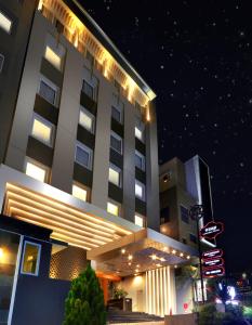 un gran edificio con luces encendidas por la noche en Pranaya Boutique Hotel, en Serpong