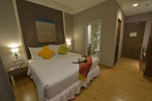 A bed or beds in a room at Pranaya Boutique Hotel