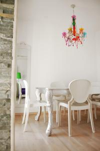 a white dining room with a white table and chairs at Good Spirit in Trogir