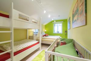two bunk beds in a room with green walls at Villa Scandic Apartments in Rust