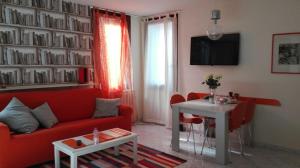 a living room with a red couch and a table at Bacanal Apartment in Venice