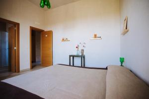 a bedroom with a large bed and a hallway at Piccapane Vegan Farm in Cutrofiano