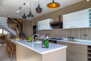 a kitchen with white cabinets and a counter top at Villa Panorama in Kalkan