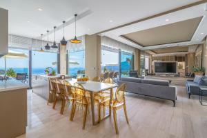a dining room and living room with a table and chairs at Villa Panorama in Kalkan