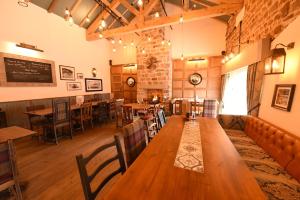 a restaurant with wooden tables and chairs and a bar at The Royal Heysham in Heysham