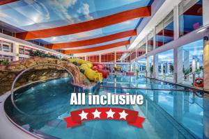 an all inclusive hotel swimming pool with a water slide at Aquapark Health Resort & Medical SPA Panorama Morska All Inclusive in Jarosławiec
