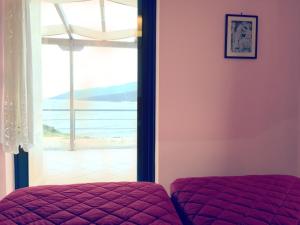 a bedroom with a bed and a view of a beach at Ravishing View, Zastani Houses in Marmari