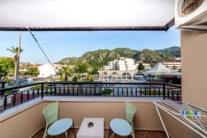 a balcony with chairs and a view of a city at Lighthouse Apartments in Marmaris