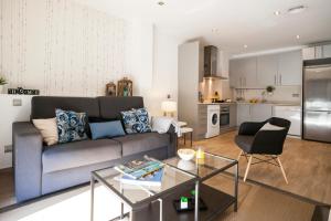 a living room with a couch and a table at Feelathome Mozart Apartments in Barcelona