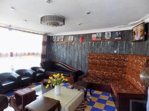 a living room with leather furniture and a couch at Star Royal Motel Kitebi Kampala in Kampala