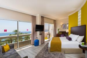 a hotel room with a bed and a view of the ocean at Leonardo Plaza Hotel Eilat in Eilat