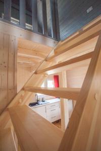 a tiny house with a kitchen in the middle at fajnemorze - Domy Szwedzkie in Dębina-Ustka +13 photos
