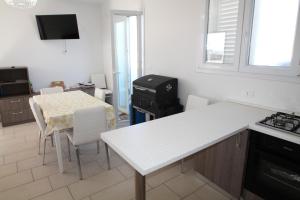 a kitchen with a table and a counter top at Summer in Gallipoli