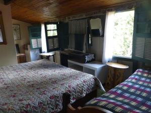Postel nebo postele na pokoji v ubytování Pouso das Glicínias - B&B