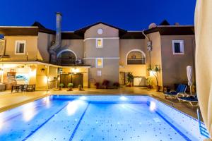 a large swimming pool in front of a house at Lighthouse Apartments in Marmaris
