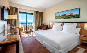 a hotel room with a bed and a balcony at Barceló Punta Umbría Mar in Punta Umbría