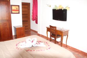 a bedroom with a bed with two white hearts at Residence Hotel Torresilvana in Vieste