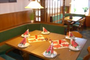 a wooden table with slices of pizza on it at Hotel Bürgerstube in Hitzacker