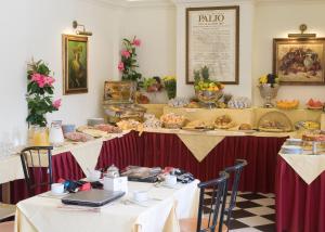 a set of tables with food on them at Hotel Palazzo dei Priori in Siena