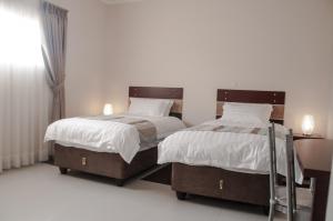 Кровать или кровати в номере Bannerloft Guest house